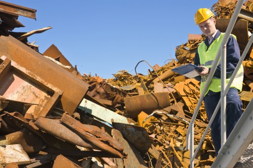 Staff assisting with accessible bin area at a commercial site